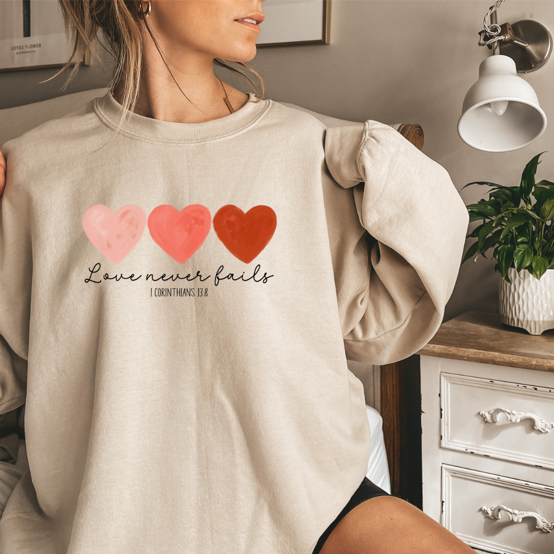 LOVE NEVER FAILS- 1 COR 13:8 SWEATSHIRT