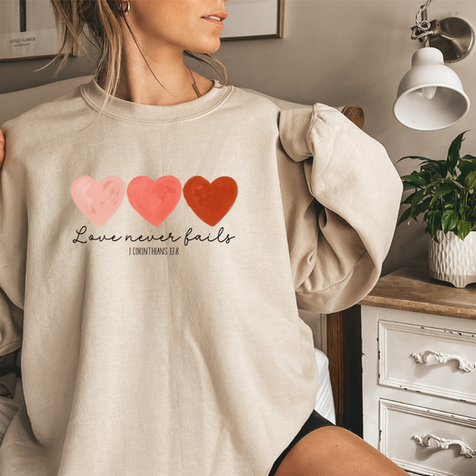 LOVE NEVER FAILS- 1 COR 13:8 SWEATSHIRT